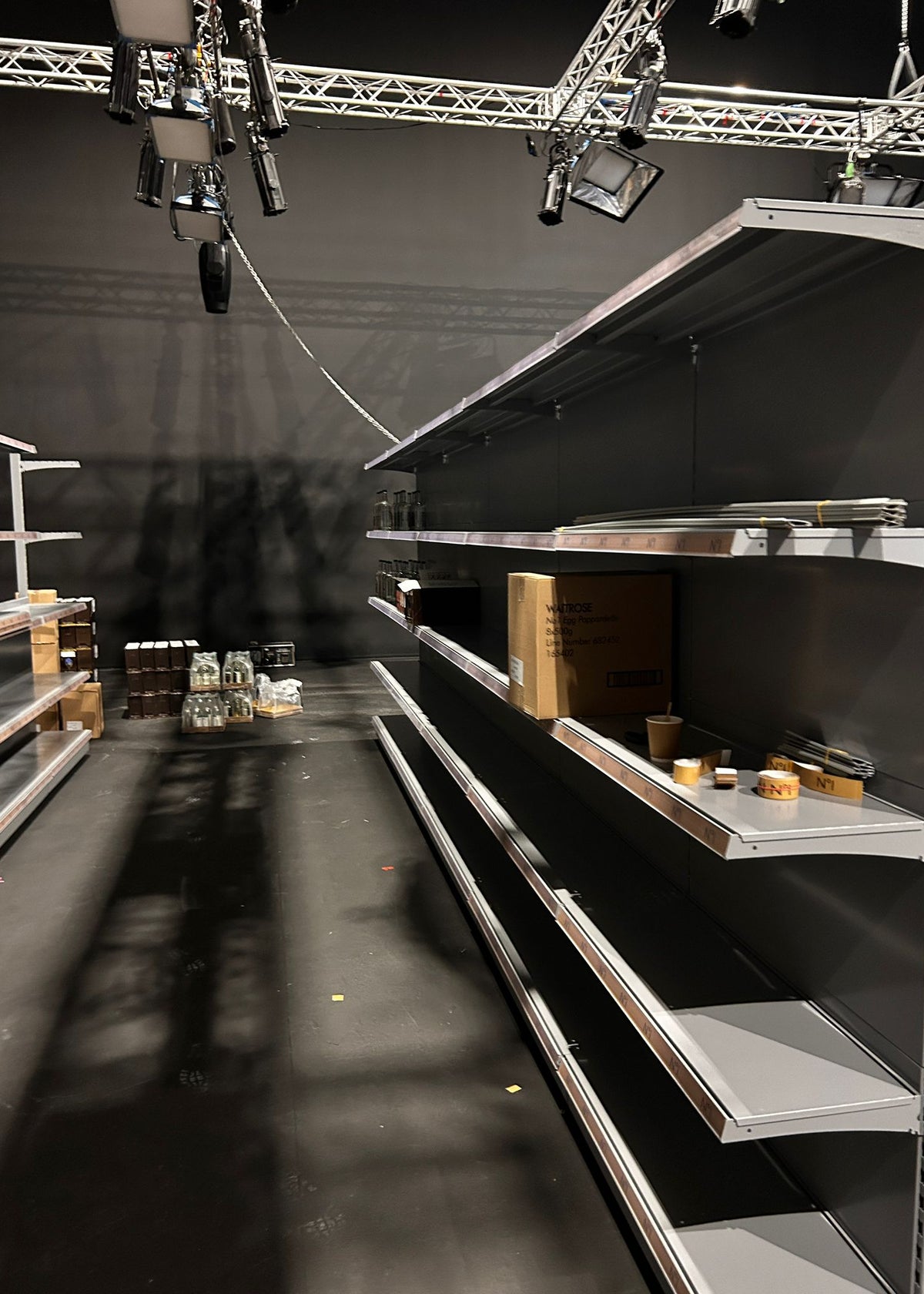 Dark Grey empty shop shelves in a television studio.