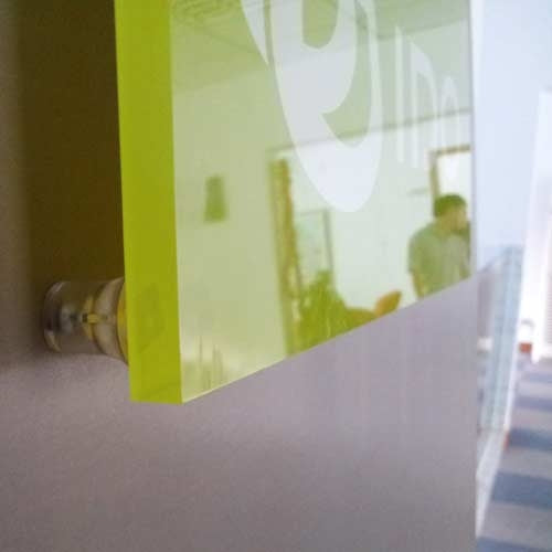 an example of a graphic shape fixed to he wall with a clear letter fixing